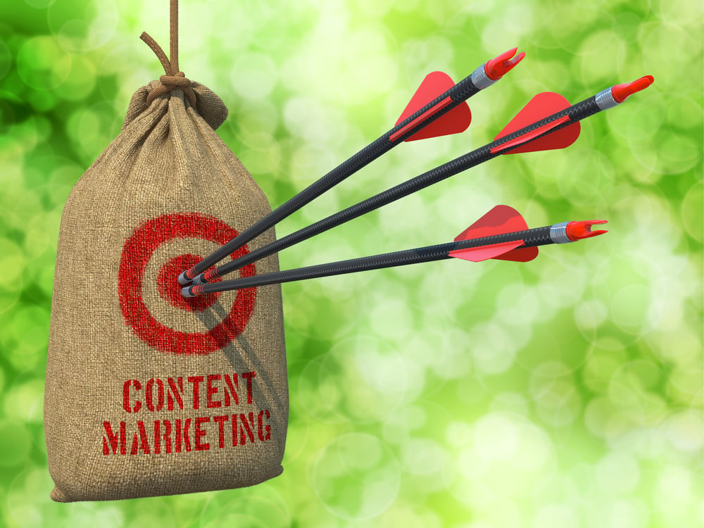 Content Marketing - Three Arrows Hit in Red Target on a Hanging Sack on Natural Bokeh Background.-1